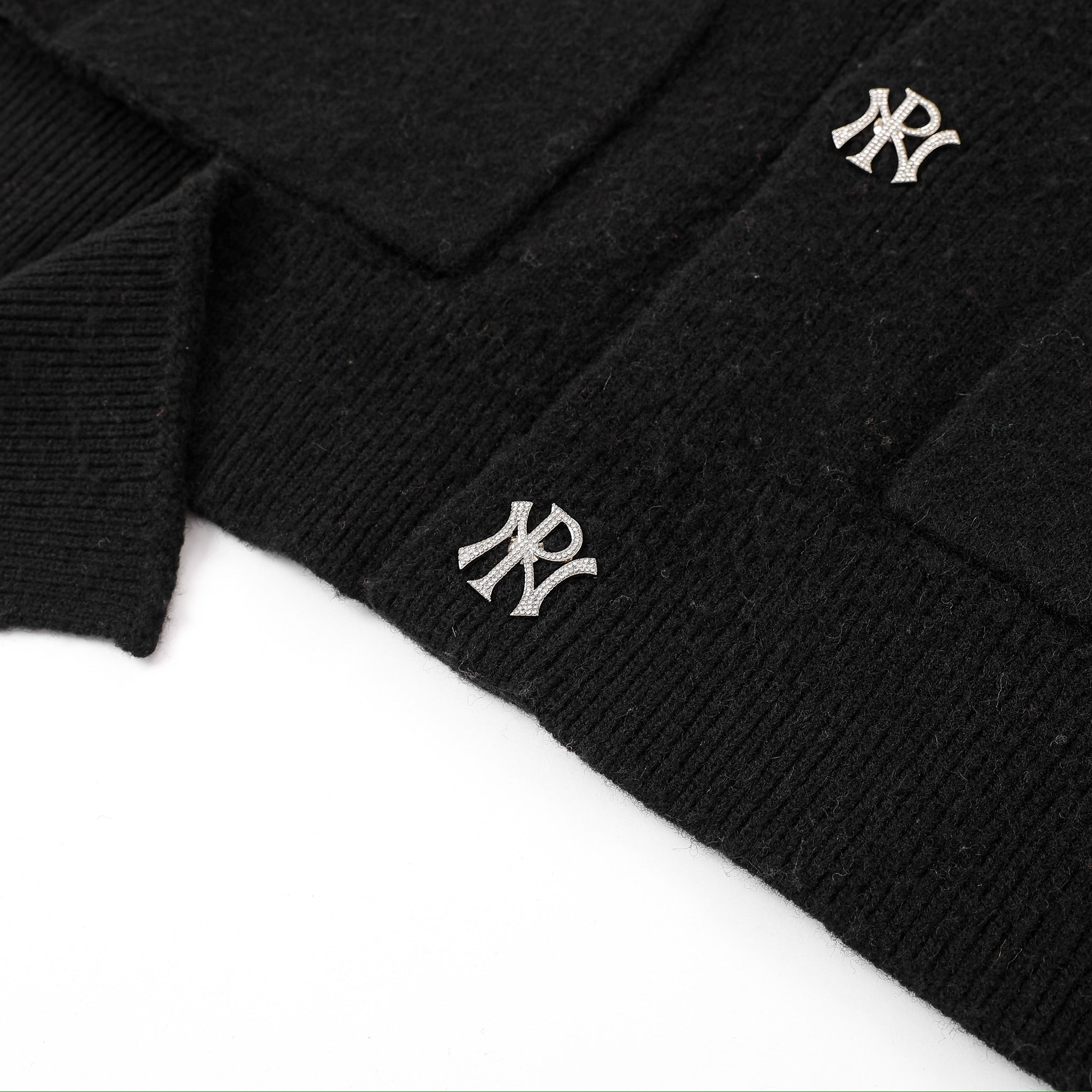 Black sweater with NP logo on a white background